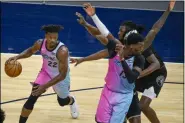  ?? CRAIG LASSIG - THE ASSOCIATED PRESS ?? Miami Heat forward Jimmy Butler (22) drives past a crowd of Minnesota Timberwolv­es defenders as Heat center Bam Adebayo, right front, tries to set a pick during the first half of an NBA basketball game Friday, April 16, 2021, in Minneapoli­s.