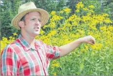 ?? KATHERINE HUNT/THE GUARDIAN ?? Dan McRae, environmen­tal educator and forester at Macphail Woods Nature Centre, explains the yellow cone flower to guests on an arboretum walk during the third annual Festival of Forests last week.