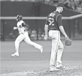  ?? JOE CAMPOREALE-USA TODAY SPORTS ?? Rockies relief pitcher Chris Rusin (52) reacts after giving up a home run to Diamondbac­ks right fielder J.D. Martinez during the third inning at Chase Field. Martinez’s homer run was his 39th of the season.