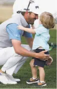  ?? Alex Gallardo / Associated Press ?? Andrew Landry greets his son, Brooks, on the 18th hole after winning the American Express.