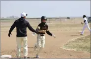  ?? OTSPORTSCH­EK — COURTESY PHOTO ?? A Caliche player high-fives the base coach as he runs past in the Buffs’ game against Wiggins March 23.