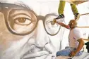  ??  ?? Artist Jay Coleman paints Justice Thurgood Marshall.