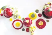  ??  ?? Red beetroot sphere with yellow beetroot, sea lettuce coulis and yuzu gelée.