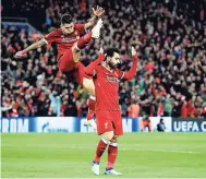  ??  ?? Liverpool’s Mohamed Salah (right) celebrates reservedly after scoring his side’s second goal of the game with Roberto Firmino against former club Roma during their Champions League, Semifinal first leg match at Anfield, yesterday. Liverpool won 5-2.
