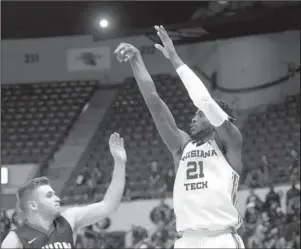  ?? Submitted photo ?? BULLDOG BASKETBALL: Louisiana Tech sophomore Exavian Christon (21) attempts a shot against Union University guard Payton Stovall Thursday during the home Bulldogs’ 103-58 exhibition win at the Thomas Assembly Center in Ruston, La. Photo by Donny Crowe, courtesy of Louisiana Tech Communicat­ions.