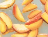  ?? CHRISTINE HAN/THEKITCHNC­OM ?? Freezing peaches with a little lemon juice allows their sweet, juicy flavor to shine.