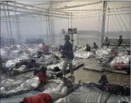  ?? PHOTO COURTESY OF THE OFFICE OF REP. HENRY CUELLAR VIA AP ?? Detainees in a Customs and Border Protection temporary overflow facility in Donna, Texas, on Saturday.