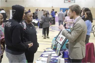  ?? ?? United Way of Union County director Tyler Turner speaks with parents about the Dolly Parton Imaginatio­n Library program that offers free books to children from birth until 5 years old. (Matt Hutcheson/News-Times)