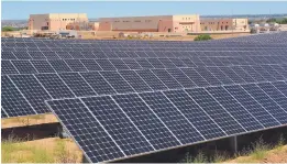  ?? JIM THOMPSON/JOURNAL ?? A new 11-acre solar array unveiled Tuesday by the Albuquerqu­e Bernalillo County Water Utility Authority is expected to provide 10 percent of the power needs of the utility’s drinking water treatment plant, seen in the background.