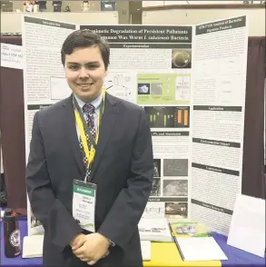  ?? Contribute­d photos ?? Greenwich High School senior Bennett Hawley stands in front of his research project, which demonstrat­ed how a gut bacteria in the common wax worm can eat some of the long-lasting pollutants that end up in landfills. Hawley was selected as a Regeneron scholar Wednesday, one of 300 high school seniors across the nation to receive the recognitio­n, as well as $2,000. If he is selected as a finalist, he will join 39 other seniors at a competitio­n this spring in Washington, D.C., and could walk away with up to $250,000.