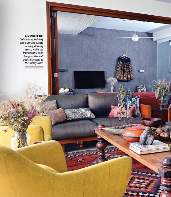  ??  ?? LIVING IT UP Colourful upholstery and cushions create a lively drawing room, while the traditiona­l lehnga hung on the wall adds character to the family room
