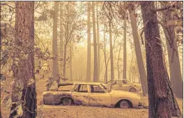  ?? NOAH BERGER — THE ASSOCIATED PRESS ?? Following the Dixie Fire, scorched cars are seen in a clearing in the Indian Falls community of Plumas County on Sunday.