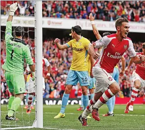  ??  ?? STING IN THE TALE: Aaron Ramsey popped up with a crucial winner in injury time