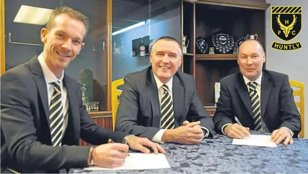  ??  ?? HAPPIER DAYS: Huntly co-managers Andy Roddie, left, and Tommy Wilson, right, with Huntly chairman George Clark in December 2016
