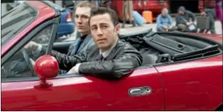  ??  ?? Joseph Gordon-Levitt (foreground) and Paul Dano in the action thriller “Looper.”