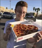  ?? PHOTO ?? Justin Beltran, 15, stares longingly at his heart shaped pizza for his special Valentine’s date. Papa John’s shows their love for Valentine’s Day by offering heart shaped pizzas throughout the month of February. CAITLIN PEBLEY