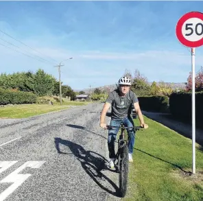  ?? PHOTO: KERRIE WATERWORTH ?? When 50 should be 40 . . . Wanaka Active Transport spokesman Simon Telfer cycles past one of the earmarked speed signs in Beacon Point Rd.