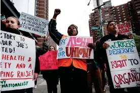  ?? Photograph: Spencer Platt/Getty Images ?? Trader Joe’s employees rally in lower Manhattan in support of forming a union on 18 April 2023.