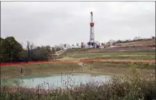  ?? KEITH SRAKOCIC — THE ASSOCIATED PRESS FILE ?? FILE – In this file photo, a drilling rig used to extract natural gas from the Marcellus Shale, located on a hill above a pond on John Dunn’s farm in the Washington County borough of Houston, Pa.