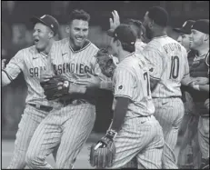  ?? Associated Press ?? HOMETOWN NO-NO — San Diego Padres starting pitcher Joe Musgrove, second from left, is mobbed by teammates after pitching a no-hitter against the Texas Rangers on Friday in Arlington, Texas. The Padres won 3-0. It was San Diego’s first nohitter in club history and the first for Musgrove, a former JetHawk who grew up in El Cajon, California.