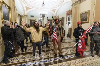  ?? MANUEL BALCE CENETA — THE ASSOCIATED PRESS ?? Supporters of President Donald Trump are confronted by U.S. Capitol Police officers outside the Senate Chamber inside the Capitol on Wednesday.