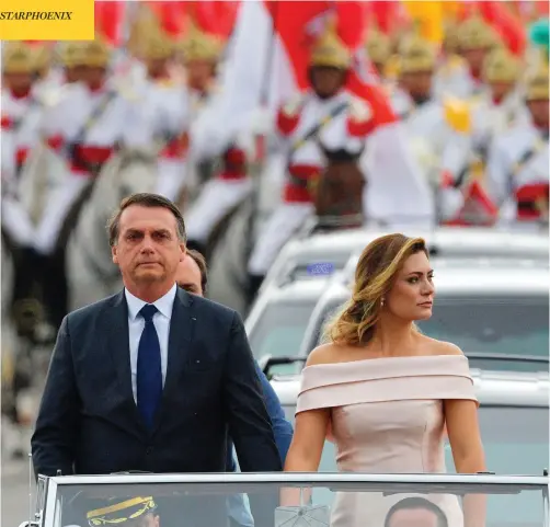  ?? CARL DE SOUZA/AFP/GETTY IMAGES ?? The presidenti­al convoy, led by Brazil’s president-elect Jair Bolsonaro and his wife Michelle, heads to the National Congress in Brasilia for his swearing-in ceremony Tuesday. Bolsonaro takes office with promises to radically change the path taken by Latin America’s biggest country.