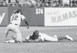  ?? CHRIS SZAGOLA AP ?? Philadelph­ia’s Kyle Schwarber slides in safely for a triple as Mets third baseman Brett Baty waits for ball in eighth inning of Game 2 of doublehead­er Saturday.