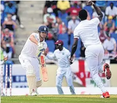  ?? AFP/GETTY ?? The England captain, Alastair Cook, is bowled for a disappoint­ing 11 by Kemar Roach in Antigua yesterday