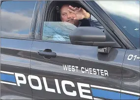  ?? PHOTOS BY PETE BANNAN - MEDIANEWS GROUP ?? Retiring West Chester police Detective Scott Whiteside waves to his family and friends as he leaves on his final day before retirement Friday.