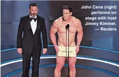  ?? ?? John Cena (right) performs on stage with host Jimmy Kimmel. — Reuters