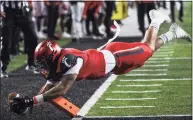  ?? Brett Coomer / Houston Chronicle ?? Cincinnati tight end Leonard Taylor dives to the pylon for a touchdown reception against Houston during the AAC championsh­ip game on Saturday.