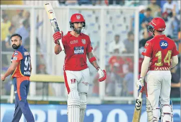  ?? PTI PHOTO ?? Kings XI Punjab batsman KL Rahul celebrates his halfcentur­y as Amit Mishra looks on.