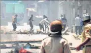  ?? HT FILE ?? A protester throws a stone at policemen during clashes in Srinagar, after Hizb commander Burhan Wani was killed in July 2016.