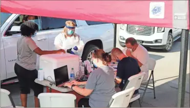  ?? John Bailey, File ?? In this September 2020 file photo, Department of Public Health workers conduct free COVID-19 tests at the Coosa Valley Fairground­s at 1400 Martin Luther King Jr. Blvd.