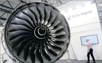  ?? PHOTO: REUTERS ?? A Rolls-Royce Trent XWB aircraft engine at the company’s booth at the ILA Berlin Air Show in Schönefeld, Germany, last year. The company has now settled a long-running bribery probe and said 2016 profit would beat expectatio­ns.
