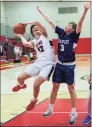  ?? Mile Wilson / Contribute­d ?? New Canaan's Christian Sweeney (12) goes up for a shot, while Staples' Derek Sale (3) defends during a boys basketball game at New Canaan High School on Feb. 24, 2020.