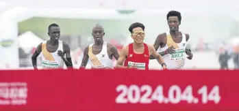  ?? ?? Chinese runner He Jie, Ethiopian Dejene Hailu Bikila and Kenyans Robert Keter and Willy Mnangat take part in a half-marathon, Beijing, China, April 14, 2024.