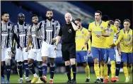  ??  ?? MAN IN THE MUDDLE: Referee Lee Mason gets VAR advice over Lewis Dunk’s free-kick ‘goal’