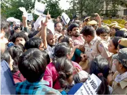  ?? — PTI ?? Police personnel and JNU students scuffle during a protest outside the UGC building in New Delhi on Friday.