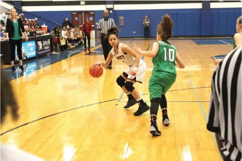  ?? Staff photo by Josh Richert ?? ■ Liberty-Eylau senior guard Kaliyah Thompson dribbles against the defense of Mabank’s Brianna Martin on Monday in a Class 4A bi-district girls playoff basketball game at Spring Hill High School in Longview, Texas. The Lady Leopards eliminated Mabank,...