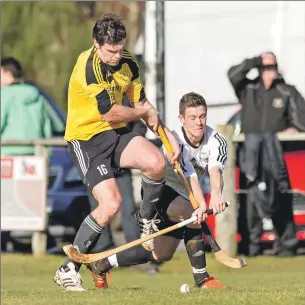  ?? Photograph­s: Neil Paterson. ?? Lovat’s Craig Mainland feels the challenge from Fort William’s Niall MacPhee.