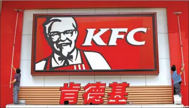  ?? REUTERS ?? Laborers clean the external wall of a KFC restaurant in Huaibei, Anhui province.