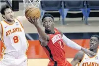  ?? MICHAEL WYKE/AP ?? Guard Victor Oladipo, center, was traded from Houston to the Miami Heat on Thursday.