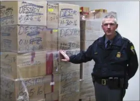  ?? ANDREW WELSH-HUGGINS — THE ASSOCIATED PRESS FILE ?? In this file photo, Ohio State Highway Patrol Lt. Robert Sellers discusses record drug seizures in 2016, as he stands next to boxes of seized drugs due for disposal in Columbus, Ohio. A police relations board created by Republican Ohio Gov. John Kasich...