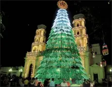  ?? AP/BETH J. HARPAZ ?? The Harpaz family visited a church in Medellin, Colombia, which was famous for its Christmas lights. A private guide drove them around the city to find the best light displays. Private tours are no longer the exclusive domain of wealthy travelers, as...