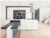  ??  ?? The kitchen includes a centre island with a stone counter and stainless steel appliances.