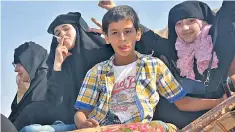  ??  ?? Manbij lies just 25 miles from Turkey, above. Right, a young woman smokes openly as her friends celebrate the SDF’s victory