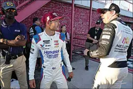  ?? CHUCK BURTON / AP ?? Kyle Larson, center, talks with Brad Keselowski, right, after arriving for the NASCAR All-Star auto race May 19 at North Wilkesboro Speedway in North Wilkesboro, N.C.