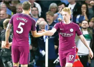  ?? IAN KINGTON/AFP ?? Manchester City midfielder Kevin De Bruyne (right) celebrates with John Stones after scoring the winner against Chelsea at Stamford Bridge on Saturday night.