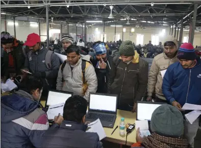  ?? (AP/Rajesh Kumar Singh) ?? Indian workers aspiring to be hired for jobs in Israel submit their forms during a recruitmen­t drive in Lucknow, India, earlier this month.
